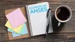 Cuaderno con logo de Anses y café