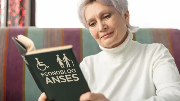 Jubilada leyendo libro de Anses para PNC y jubilaciones
